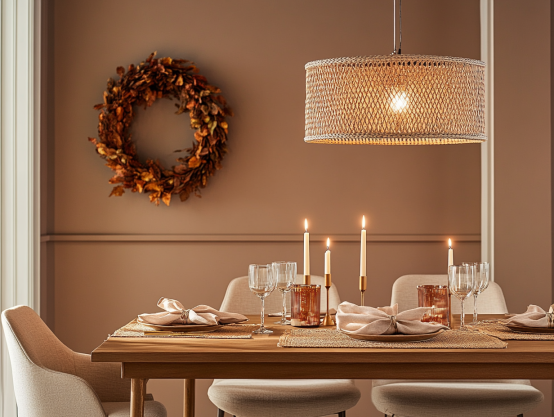 Elegant Dining Room Decor with Autumnal Warmth and Candlelight Elegant dining room with a wooden table, beige chairs, warm candlelight, a woven pendant light, and an autumn wreath on the wall.