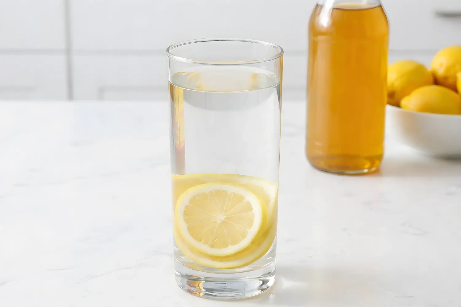 Dr. Oz apple cider vinegar drink recipe with lemon slices in a glass for detox and weight loss